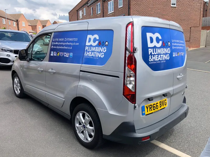 Silver DC Plumbing & Heating van on a new housing development