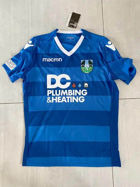 Blue football shirt sponsored by DC Plumbing & Heating