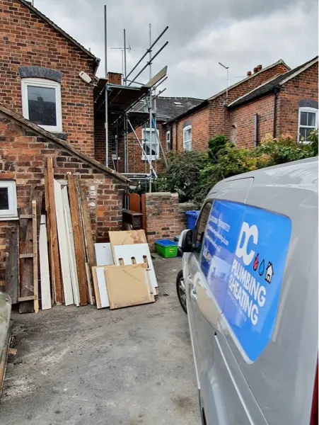 DC Plumbing & Heating van parked behind terraced houses