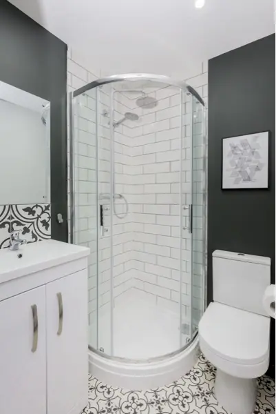Shower room with quadrant shower enclosure, toilet and vanity unit