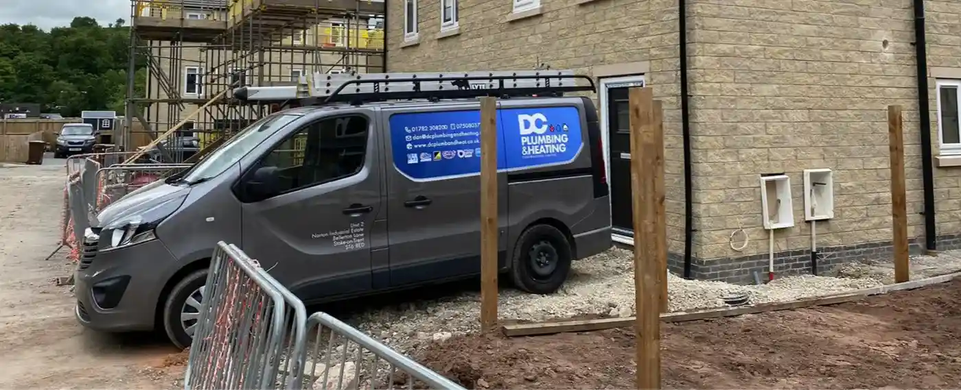 DC Plumbing & Heating van parked outside new build houses